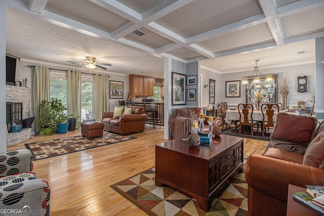 6436 Alpine Rd, Rex, GA 30273 - living area with beam ceiling, a fireplace, coffered ceiling, visible vents, and light wood-style flooring