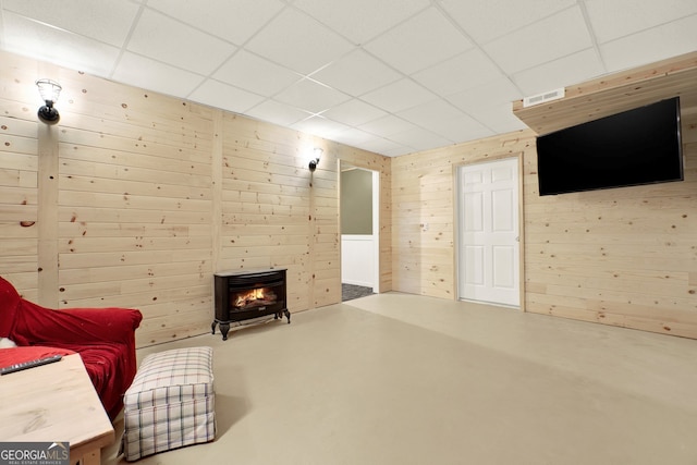 192 Aubrey Ave NE, Calhoun, GA 30701 - sitting room with a drop ceiling, wooden walls, and concrete flooring