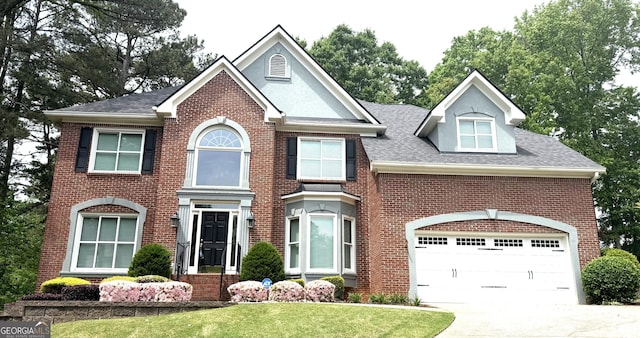 view of front of property featuring concrete driveway, roof with shingles, a front lawn, and brick siding