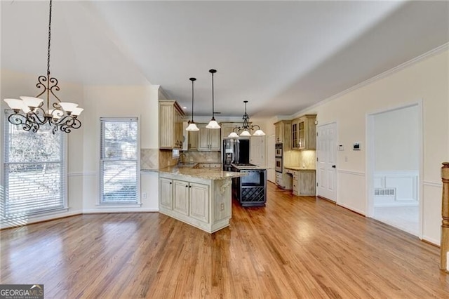 kitchen featuring fridge with ice dispenser, backsplash, a chandelier, and light wood-style floors