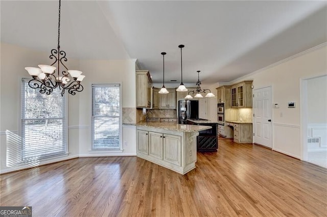 kitchen with fridge with ice dispenser, an inviting chandelier, a peninsula, and glass insert cabinets