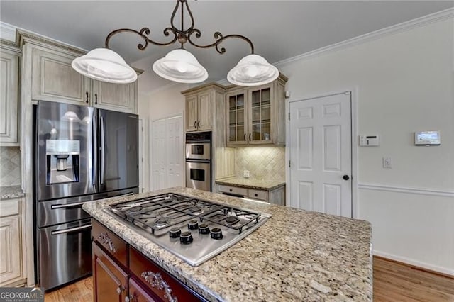 kitchen featuring stainless steel appliances, backsplash, glass insert cabinets, and ornamental molding