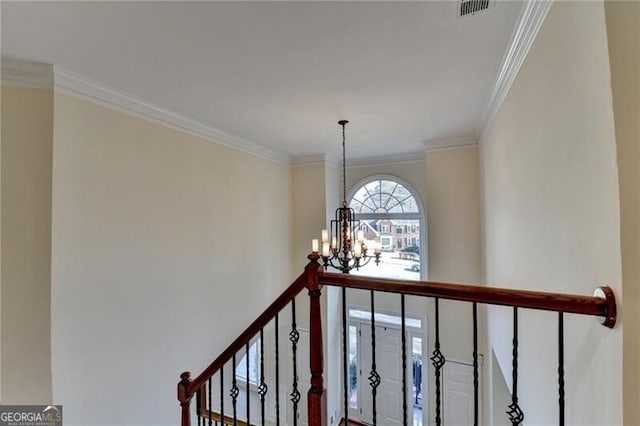 interior space featuring visible vents, ornamental molding, and a notable chandelier