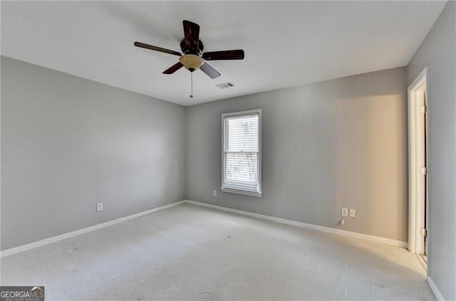 spare room featuring visible vents, baseboards, and carpet floors