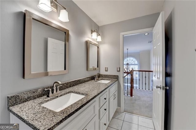 bathroom featuring double vanity, tile patterned flooring, and a sink