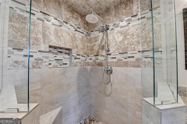 bathroom with tiled shower