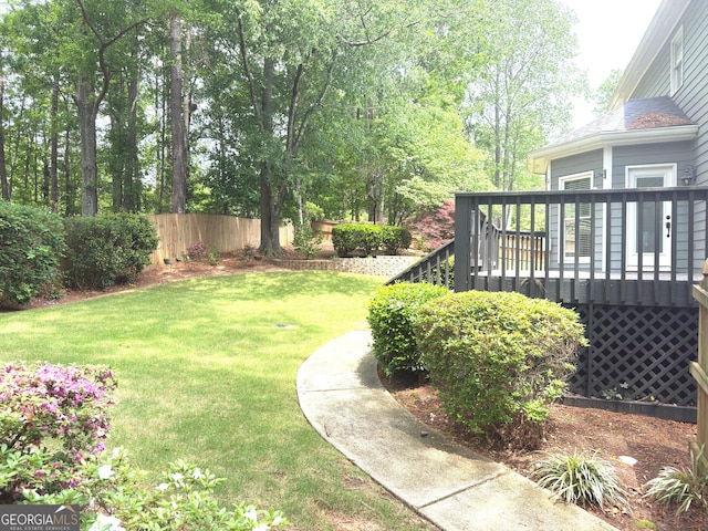 view of yard with fence and a wooden deck