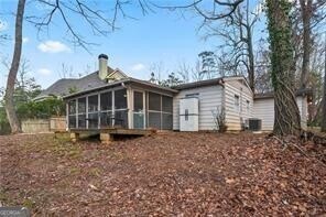 back of house featuring a sunroom and central AC unit