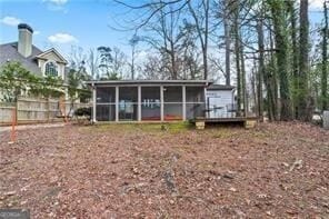 back of property with a sunroom