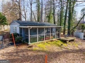 view of outbuilding with a sunroom