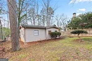 view of side of property featuring fence