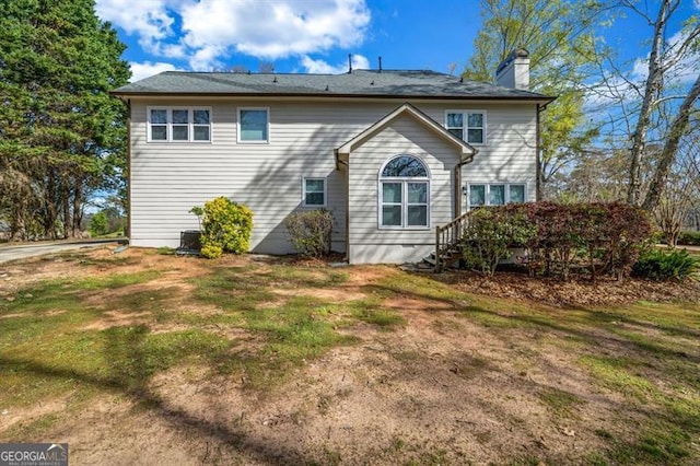 3139 Players Dr, Jonesboro, GA 30236 - back of property with a chimney and a lawn