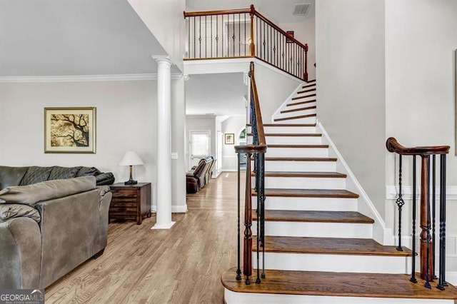 3139 Players Dr, Jonesboro, GA 30236 - stairway featuring wood finished floors, ornamental molding, baseboards, and decorative columns