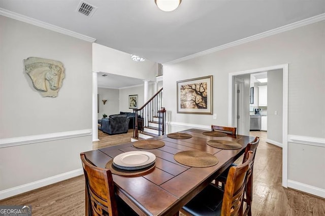 3139 Players Dr, Jonesboro, GA 30236 - dining area featuring stairway, wood finished floors, ornamental molding, and baseboards