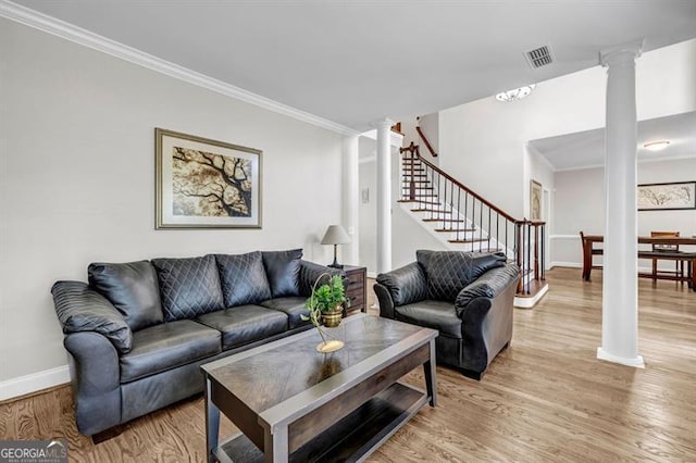 3139 Players Dr, Jonesboro, GA 30236 - living area featuring decorative columns, crown molding, light wood-type flooring, baseboards, and stairway