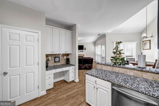 3139 Players Dr, Jonesboro, GA 30236 - kitchen with stainless steel dishwasher, white cabinets, light wood-style flooring, backsplash, and crown molding