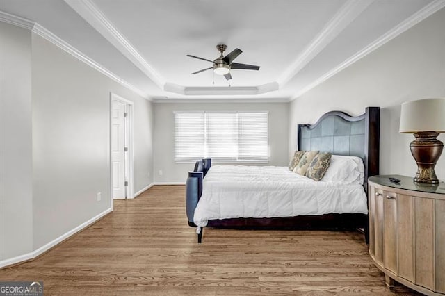 3139 Players Dr, Jonesboro, GA 30236 - bedroom with wood finished floors, a tray ceiling, ornamental molding, baseboards, and ceiling fan
