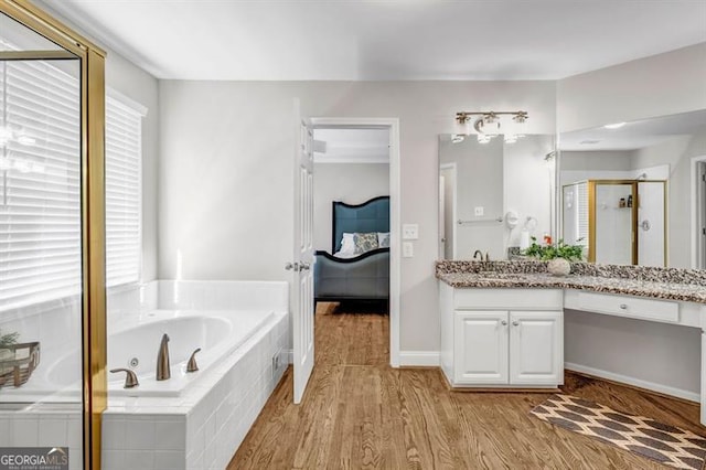 3139 Players Dr, Jonesboro, GA 30236 - full bathroom with ensuite bathroom, vanity, a bath, a shower stall, and wood finished floors