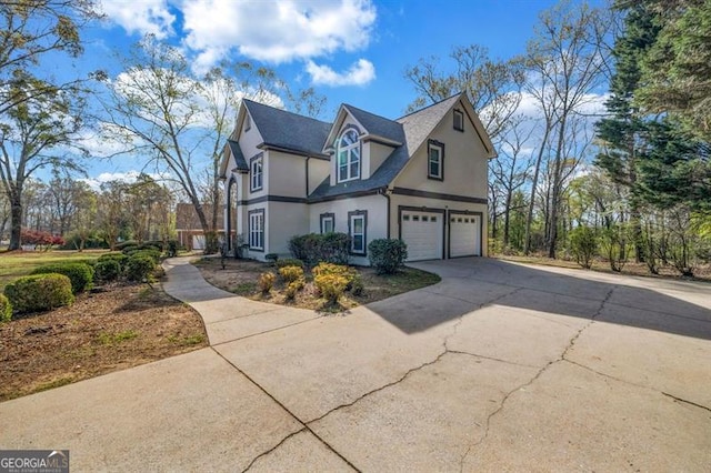 3139 Players Dr, Jonesboro, GA 30236 - view of property exterior featuring stucco siding, driveway, and an attached garage