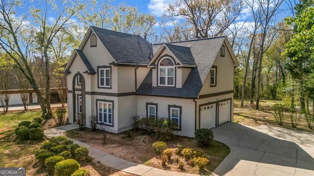 3139 Players Dr, Jonesboro, GA 30236 - tudor-style house with stucco siding, an attached garage, driveway, and roof with shingles