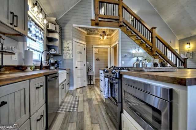 517 Monet Dr Unit 1144R, Ellijay, GA 30540 - kitchen featuring wooden counters, stainless steel dishwasher, open shelves, light wood-style flooring, and wood walls