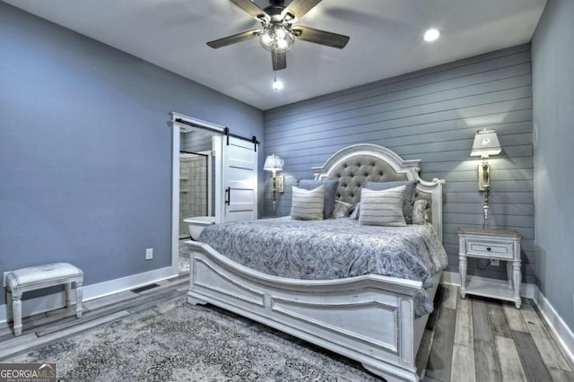 517 Monet Dr Unit 1144R, Ellijay, GA 30540 - bedroom featuring a barn door, wood finished floors, connected bathroom, and a ceiling fan