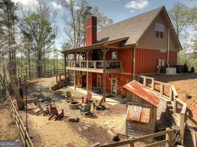 517 Monet Dr Unit 1144R, Ellijay, GA 30540 - rear view of house featuring an outdoor fire pit, a patio area, roof with shingles, a chimney, and board and batten siding