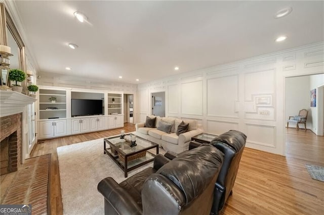 5520 Glen Errol Rd, Atlanta, GA 30327 - living room featuring a decorative wall, light wood-style flooring, a fireplace, and recessed lighting