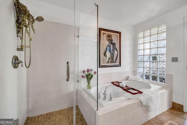 full bathroom with a shower stall, tile patterned floors, and a garden tub