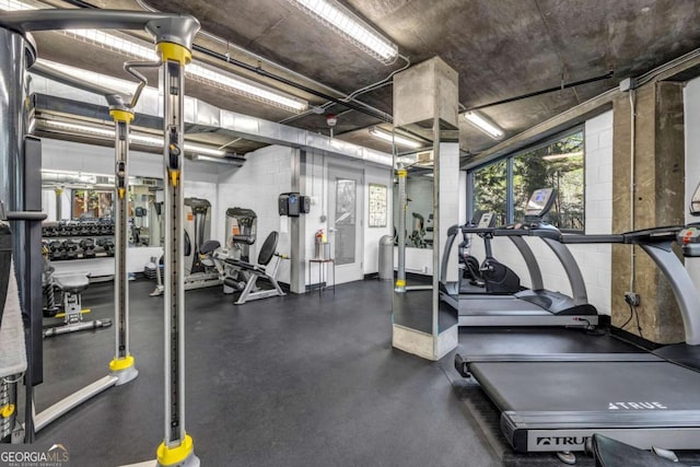workout area with concrete block wall