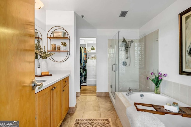 bathroom with vanity, tile patterned flooring, a shower stall, visible vents, and a garden tub
