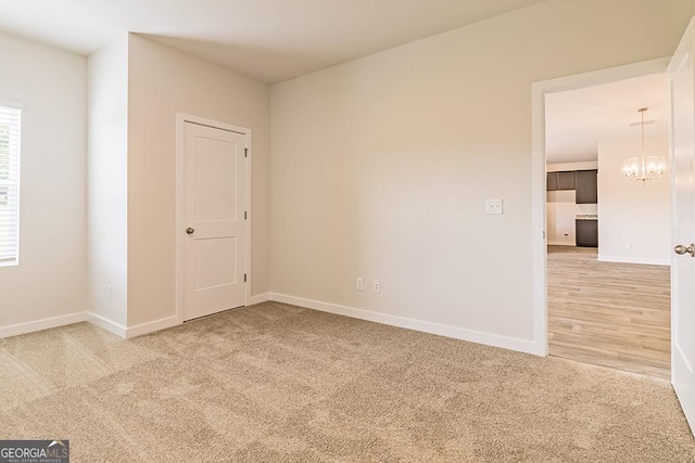 308 Brooks Dr Unit 80, Fairburn, GA 30213 - unfurnished room featuring light carpet and a chandelier