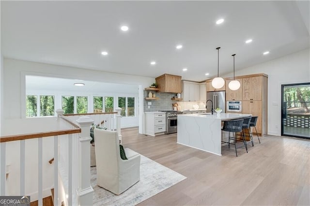 808 Sherwood Rd, Gainesville, GA 30501 - kitchen featuring stainless steel appliances, open shelves, a kitchen bar, backsplash, and an island with sink