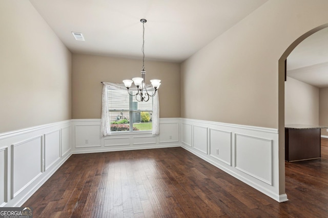 4580 Orchard Ridge Ct, Cumming, GA 30028 - unfurnished dining area featuring arched walkways, dark wood-type flooring, a notable chandelier, and a wainscoted wall