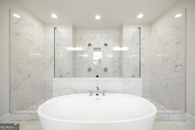 full bath with a marble finish shower, marble finish floor, and a soaking tub