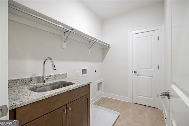 clothes washing area with baseboards, a sink, electric dryer hookup, hookup for a washing machine, and light tile patterned flooring