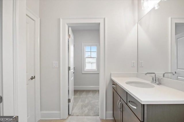 bathroom featuring vanity and baseboards