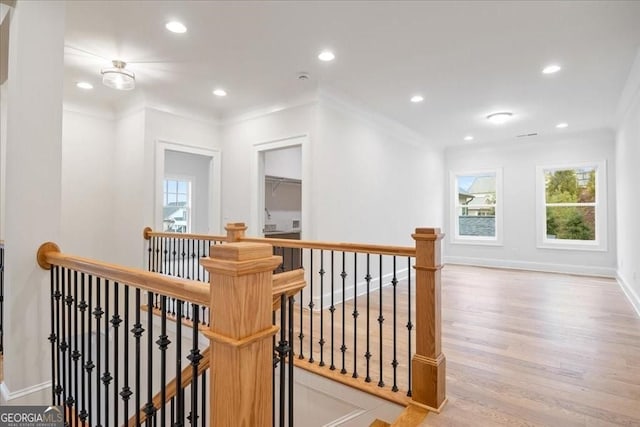 hall featuring baseboards, ornamental molding, recessed lighting, an upstairs landing, and wood finished floors