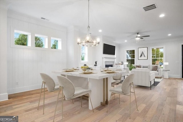 dining area featuring visible vents, baseboards, and light wood-style floors