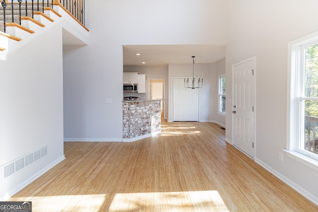 288 Pine Way, Dallas, GA 30157 - foyer with light wood-style floors, a high ceiling, a notable chandelier, and visible vents