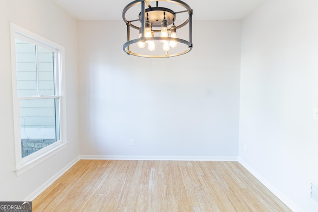 288 Pine Way, Dallas, GA 30157 - unfurnished dining area with baseboards, a notable chandelier, and wood finished floors