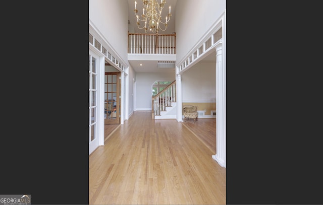 516 Turner Rd, Concord, GA 30206 - foyer with french doors, a high ceiling, stairs, light wood-style floors, and a chandelier