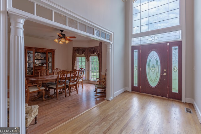 516 Turner Rd, Concord, GA 30206 - foyer entrance with light wood-type flooring, a ceiling fan, baseboards, ornate columns, and a towering ceiling