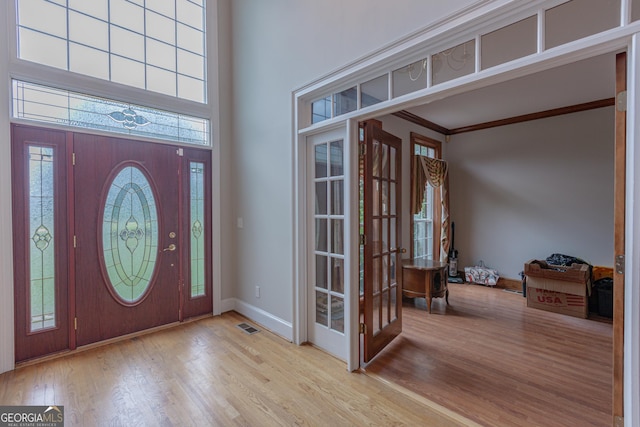 516 Turner Rd, Concord, GA 30206 - foyer entrance with french doors, wood finished floors, baseboards, a towering ceiling, and ornamental molding