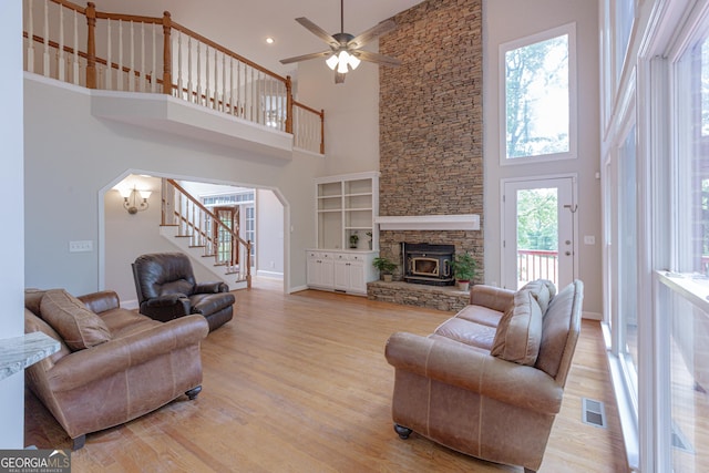 516 Turner Rd, Concord, GA 30206 - living area featuring a high ceiling, arched walkways, stairs, light wood finished floors, and baseboards