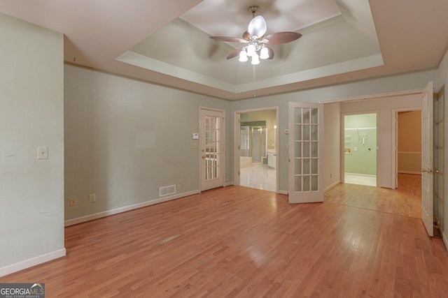 516 Turner Rd, Concord, GA 30206 - spare room featuring french doors, a raised ceiling, ceiling fan, and light wood finished floors