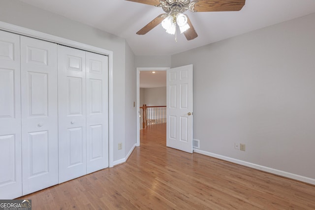 516 Turner Rd, Concord, GA 30206 - unfurnished bedroom with baseboards, light wood-style floors, a closet, and a ceiling fan