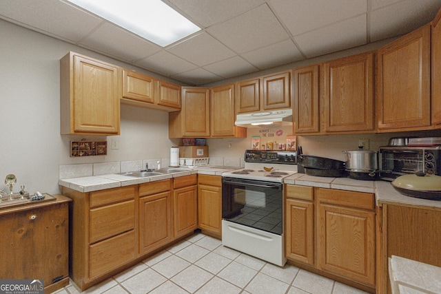 516 Turner Rd, Concord, GA 30206 - kitchen with white electric range oven, under cabinet range hood, a sink, tile counters, and light tile patterned floors