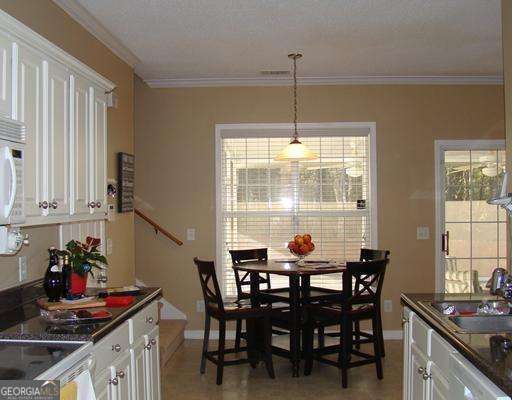 113 Sunrise Ln, Savannah, GA 31419 - dining area featuring crown molding and baseboards