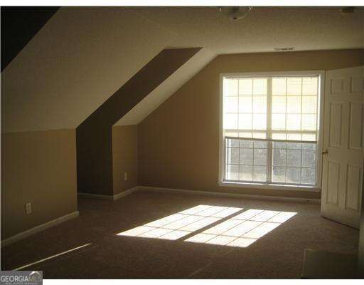 113 Sunrise Ln, Savannah, GA 31419 - bonus room featuring carpet flooring, vaulted ceiling, and plenty of natural light